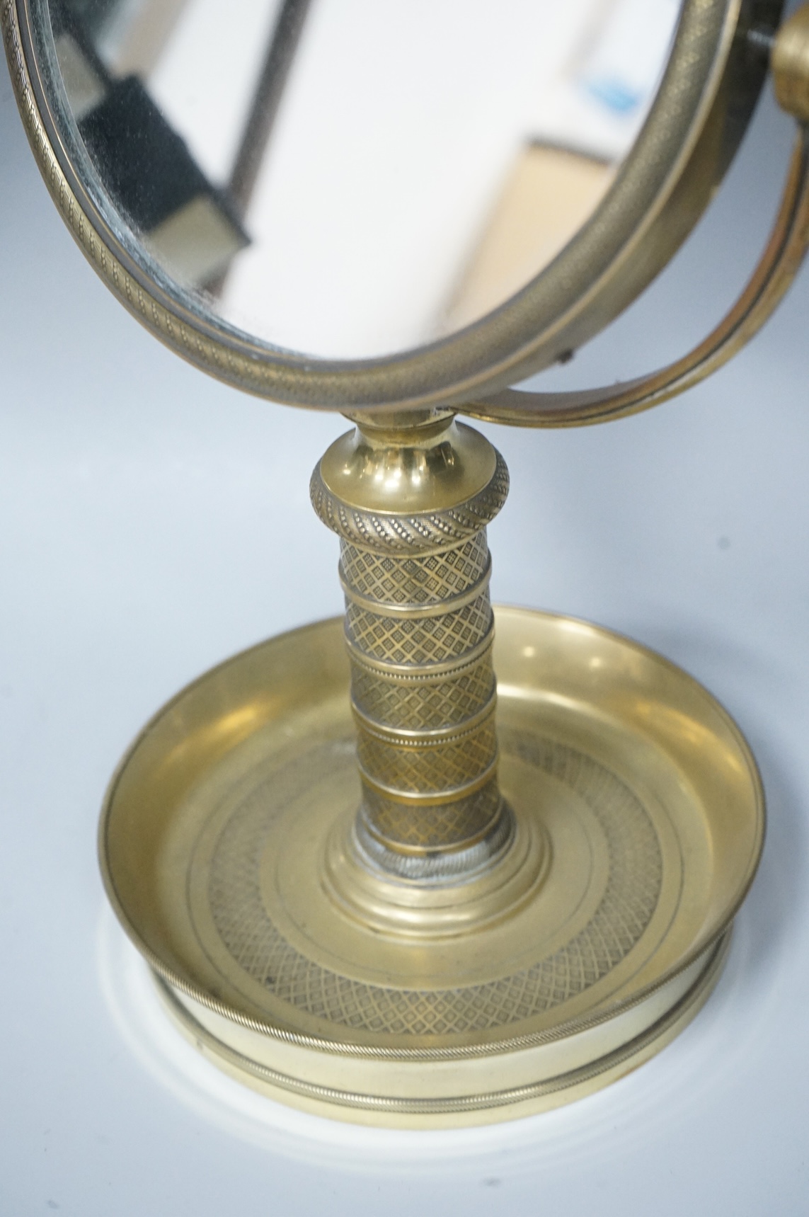 Engine turned brass shaving mirror, 35cm high